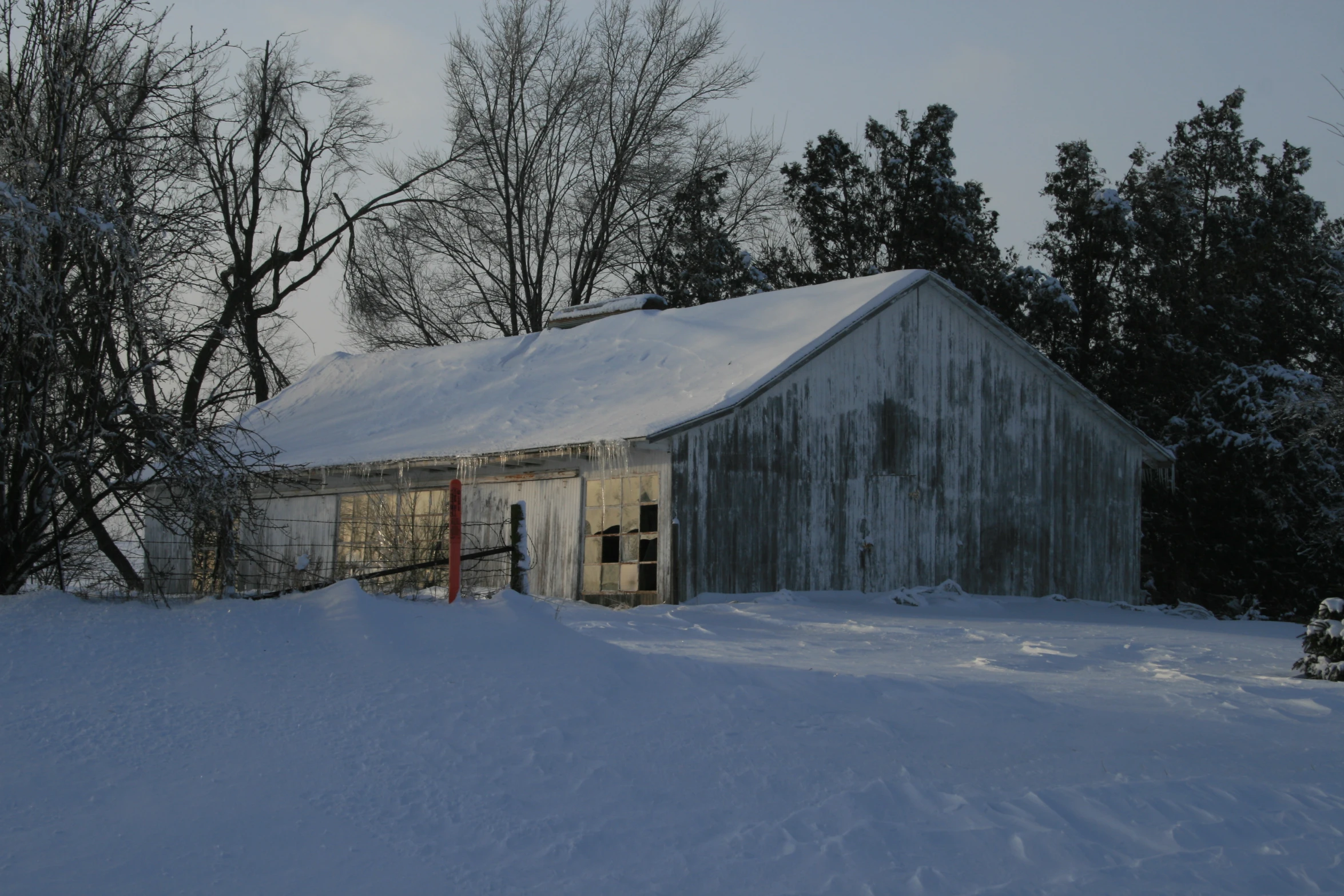 there is a small white cabin in the snow