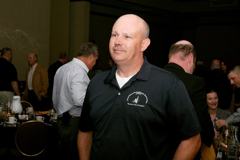 a man standing in a restaurant with people around