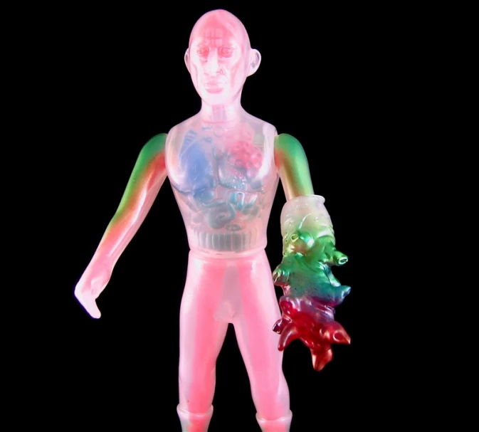 a neon colored toy figure holding a candy cane