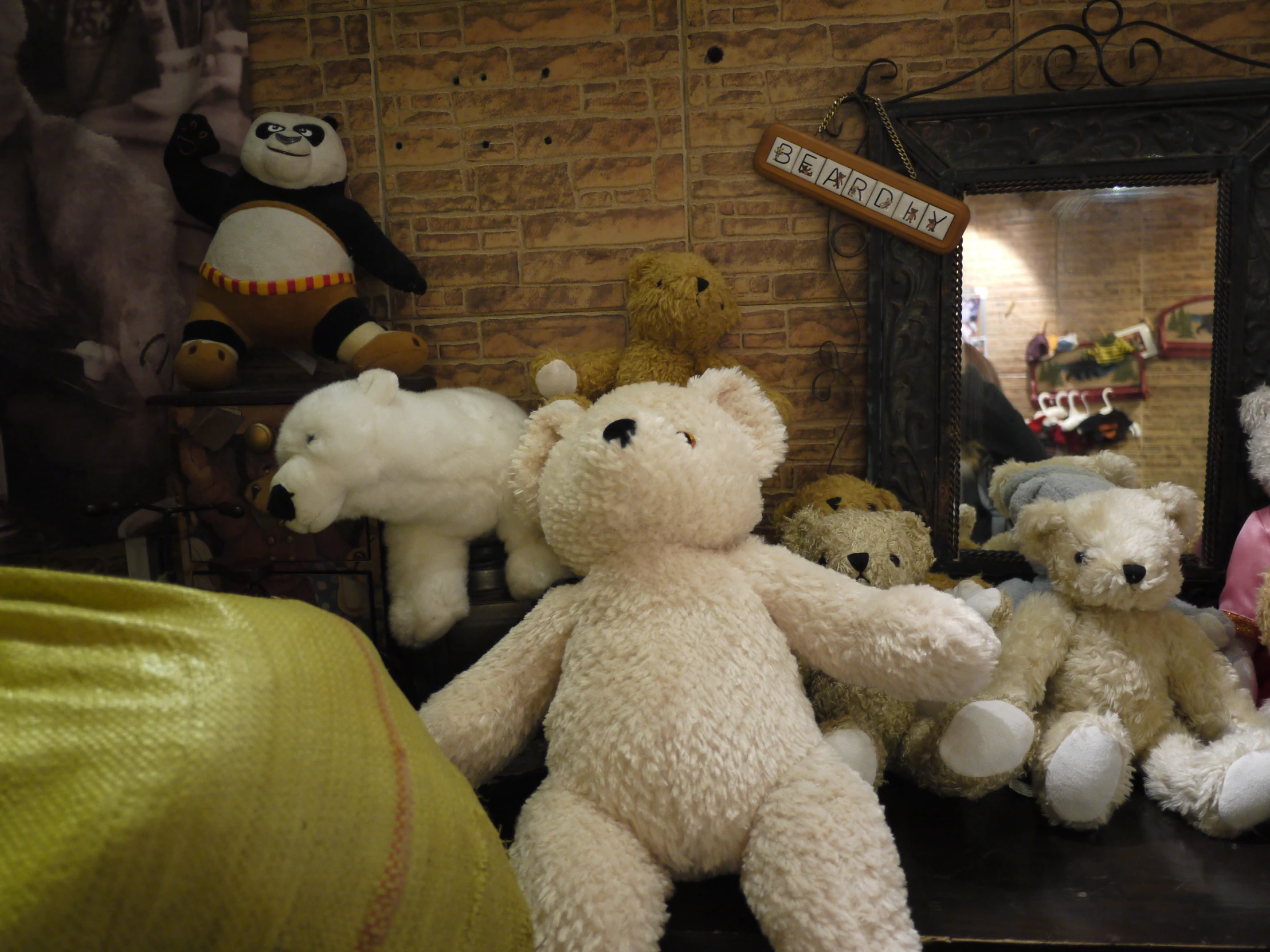 a teddy bear collection sits in front of a mirror