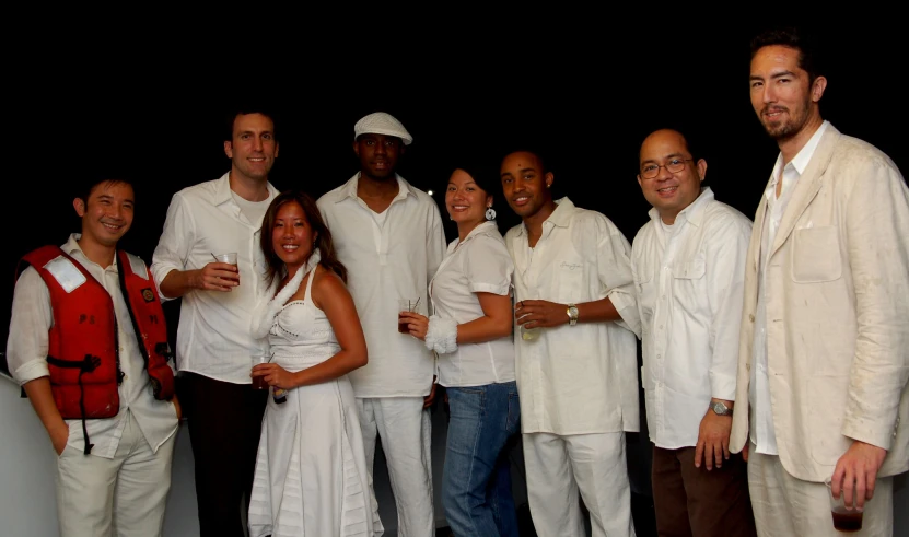 the image shows a group of people dressed in white