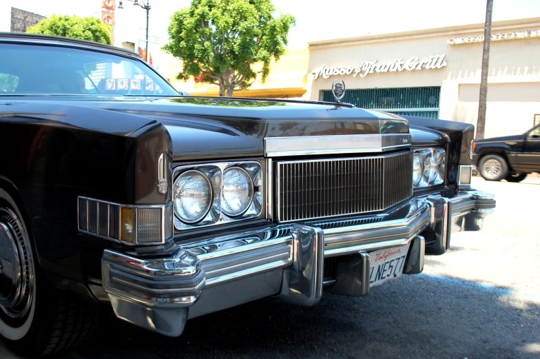 a classic car sits in the parking lot