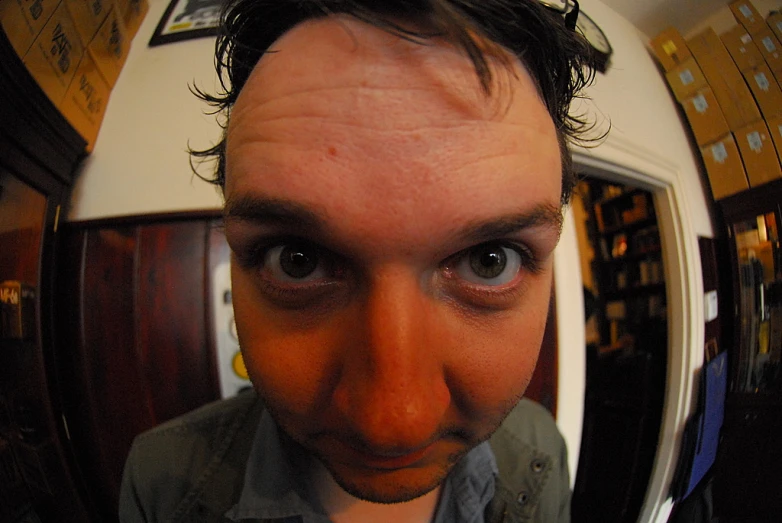 a man stares directly into the camera in a selfie