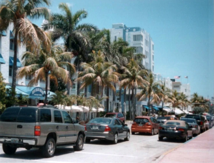 cars drive down a busy city street