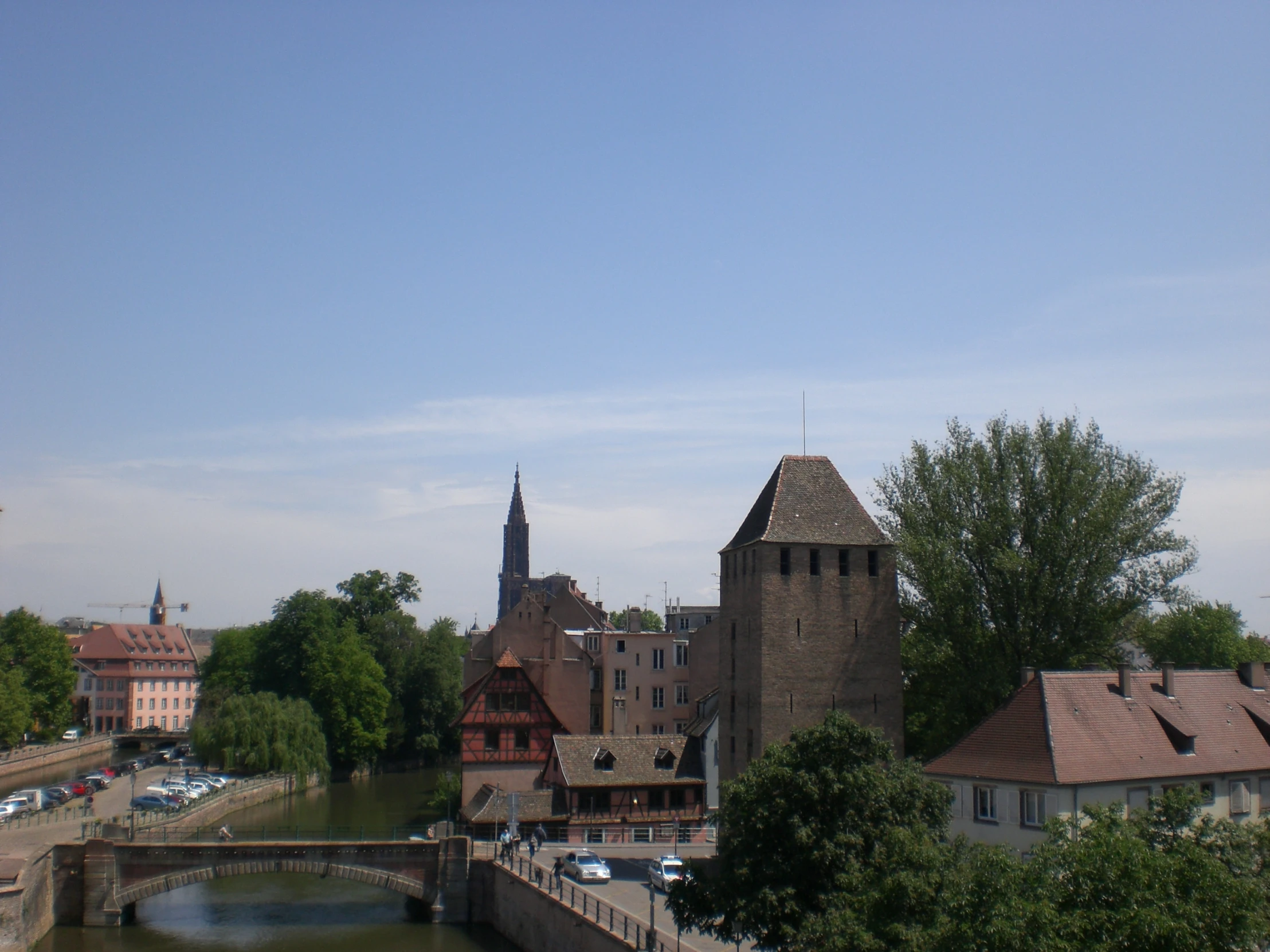 a body of water in front of a bridge and buildings