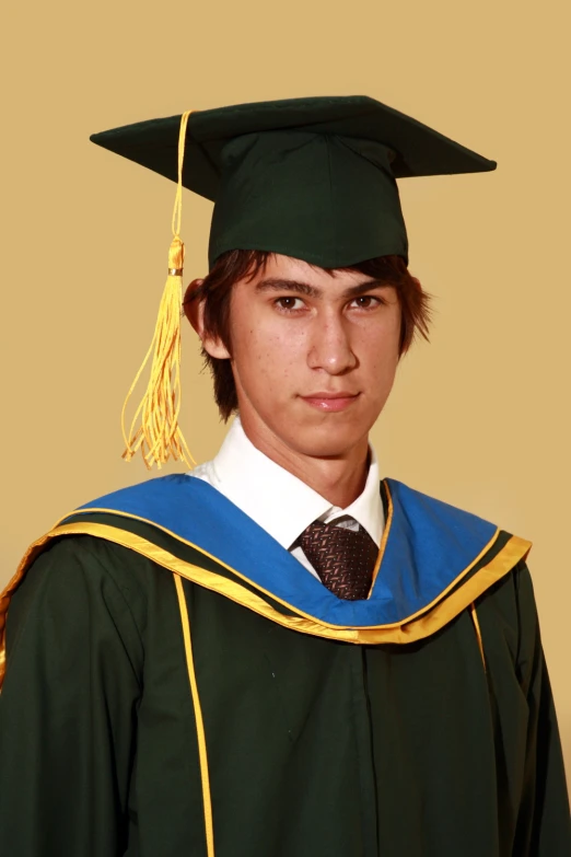 the male in the graduation gown is looking to the side