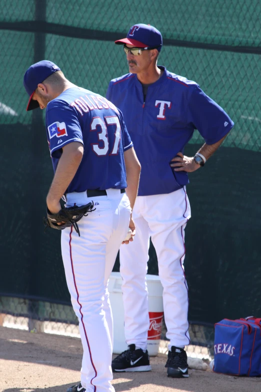 two baseball players standing next to each other