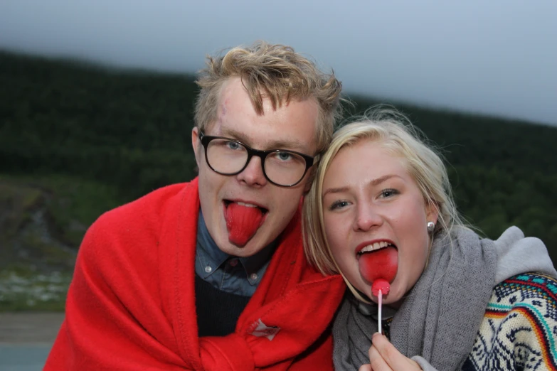 a man and woman with toothbrushes in their mouths