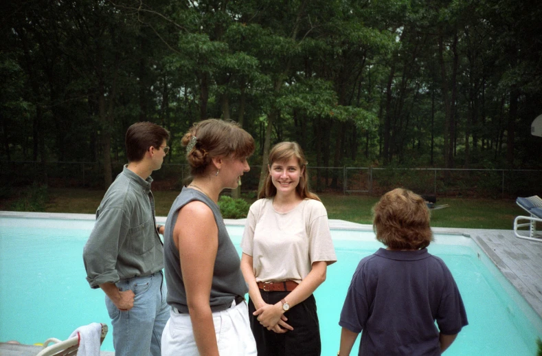 a group of people in front of a pool