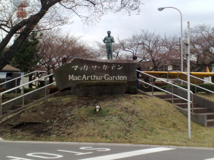 there is a statue on top of a sign