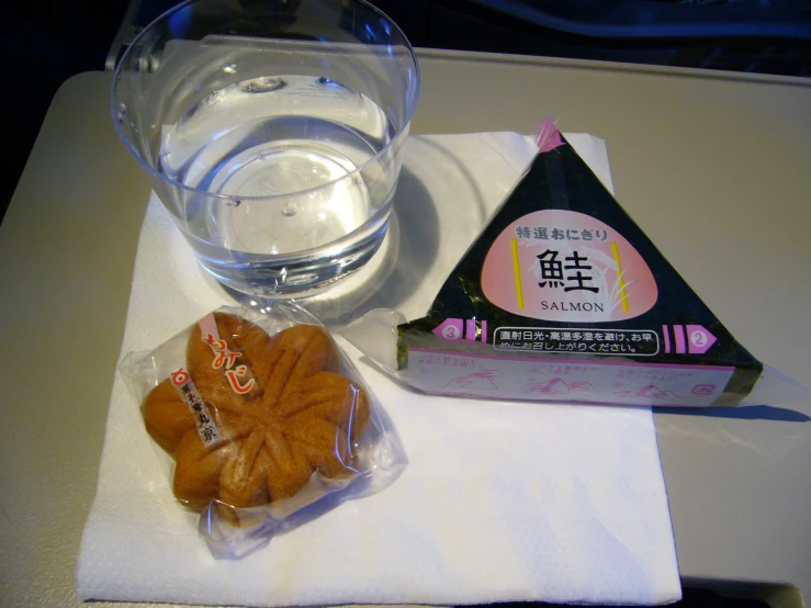 a tray topped with cookies next to a glass of water