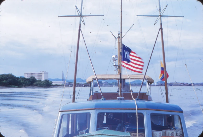 a blue boat with an american flag on top