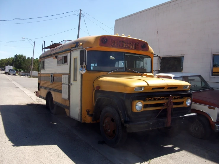 an old school bus parked in front of a building
