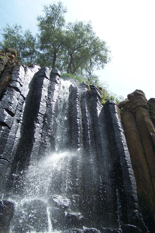 a large waterfall gushing water up into the sky