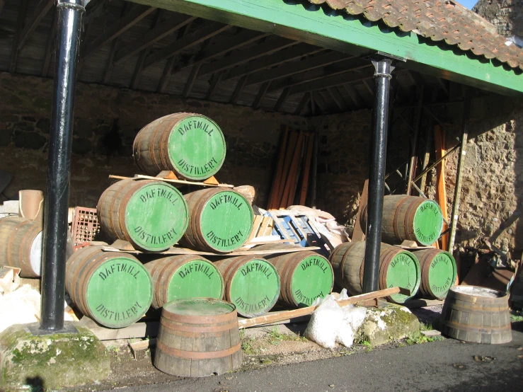 there are many barrels stacked up in front of a building