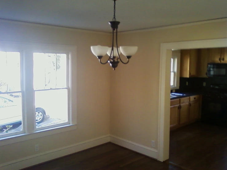 the dinning room with the door and the ceiling fan is empty