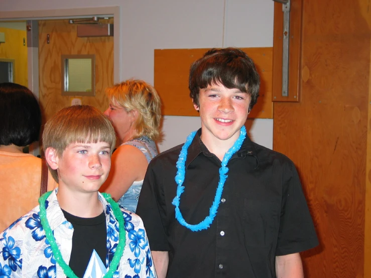 two children are standing close together at a party