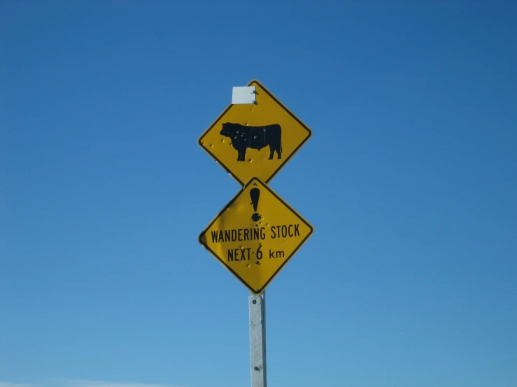 a road sign reads warning livestock meets 90
