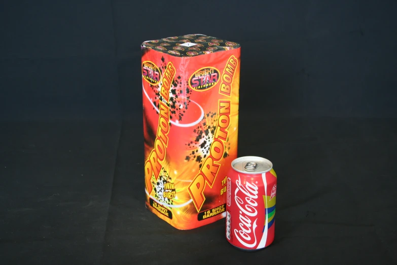 a soda can sitting next to a soda can