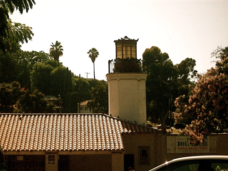 the roof of a building with a light house next to it