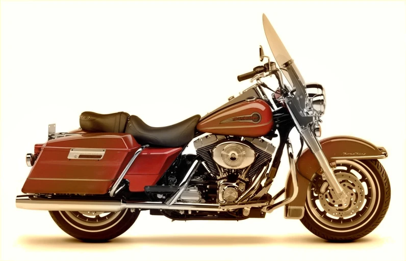 a red and brown motorcycle parked with it's back end extended