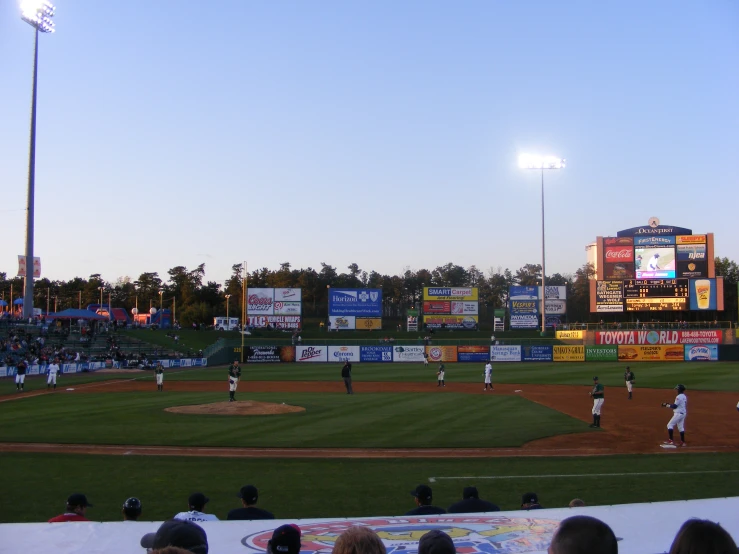 people playing a baseball game at a stadium
