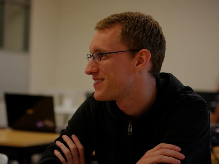 a man sitting in front of a laptop computer