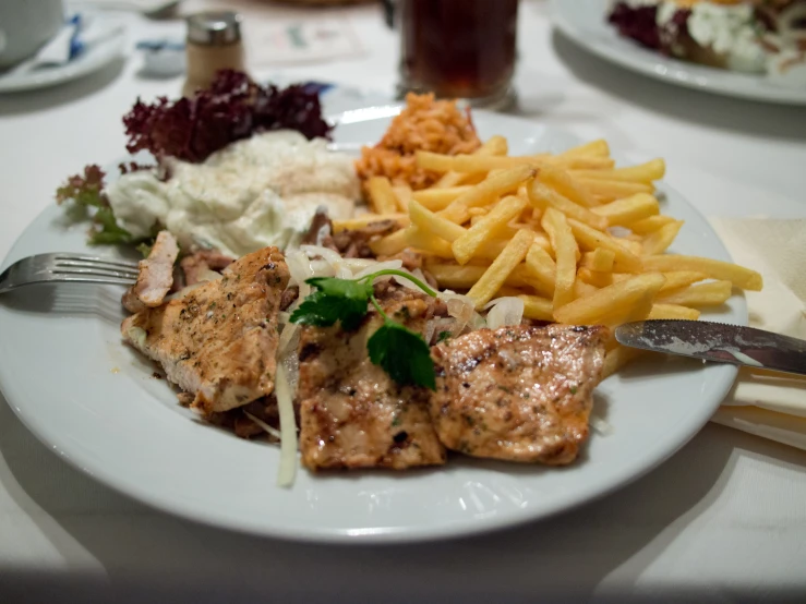 a plate topped with lots of food next to a fork