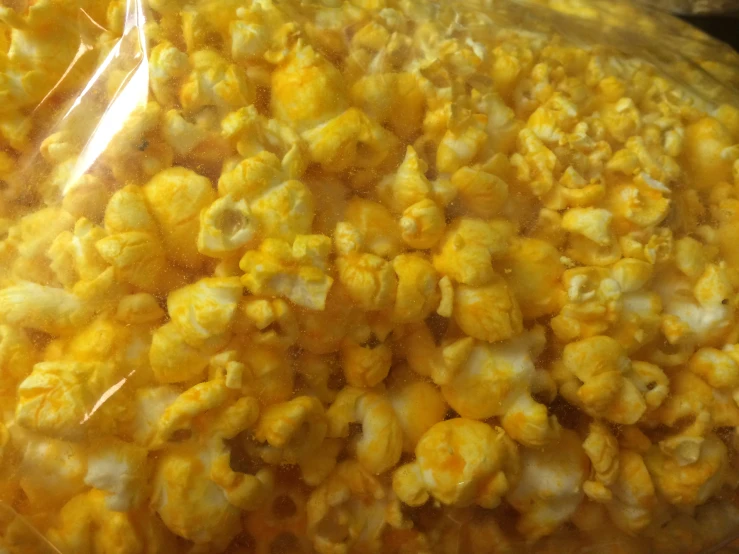 yellow popcorn sitting on the counter in plastic bags