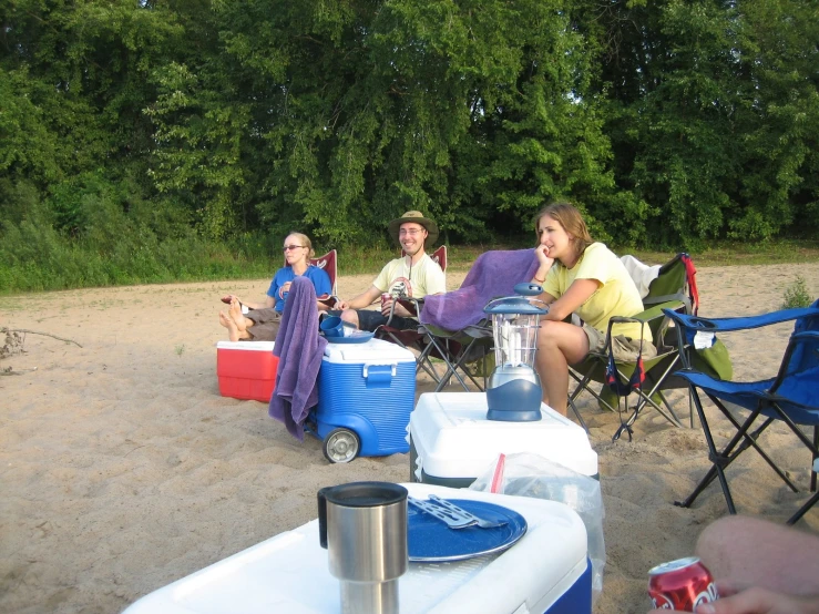 a couple of people that are sitting on some sand