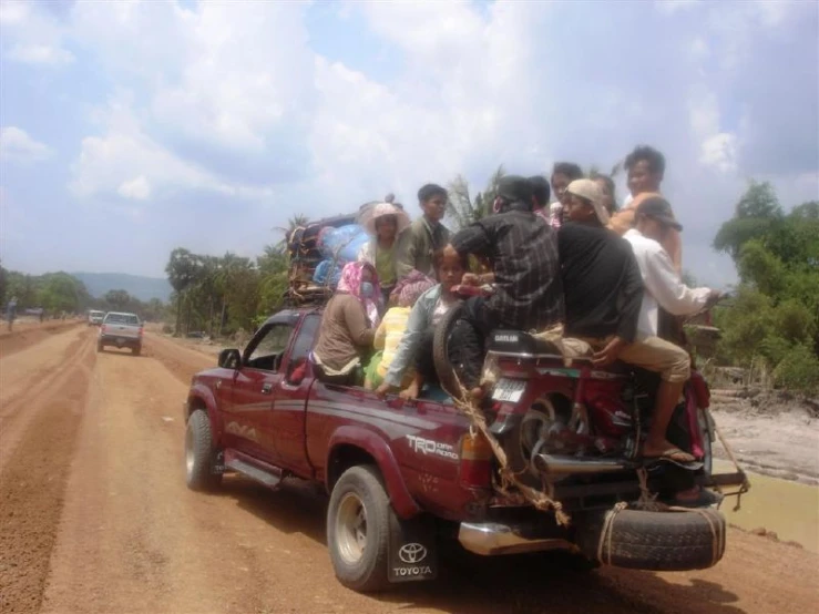 a truck has a group of people in the bed