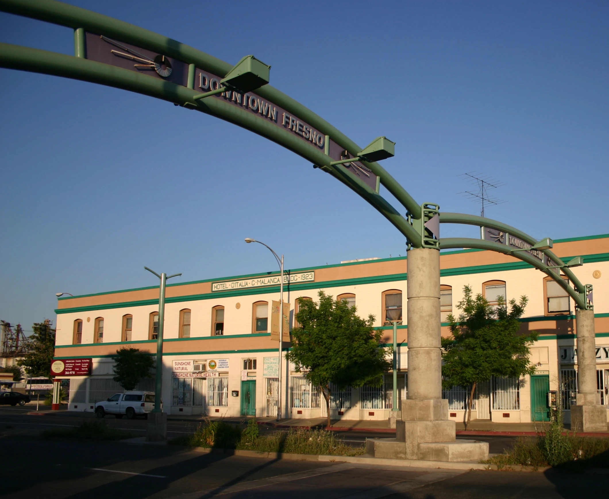 street sign in front of a building under a blue sky