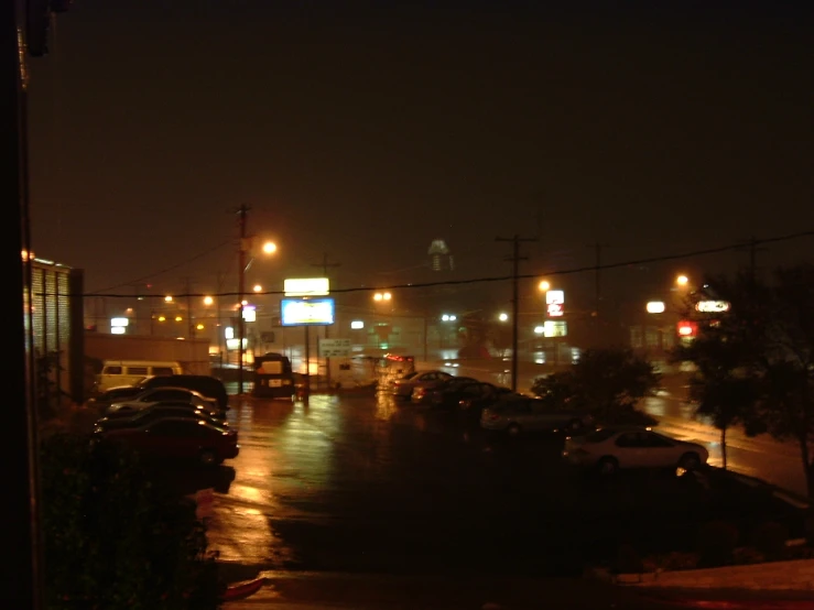 many cars are parked on the road by the street lights