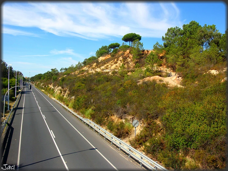 road passing through a mountainous area with trees