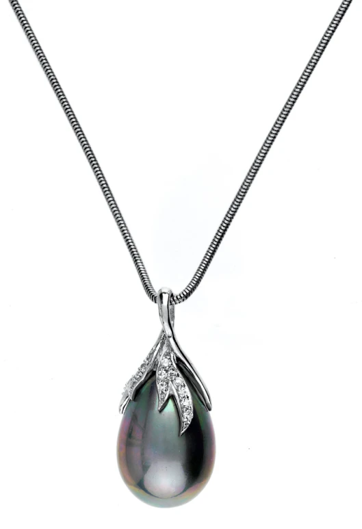 an 18 karat white gold diamond pendant necklace with a black tasseled pearl