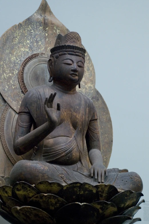 a buddha statue is sitting in the middle of a bowl