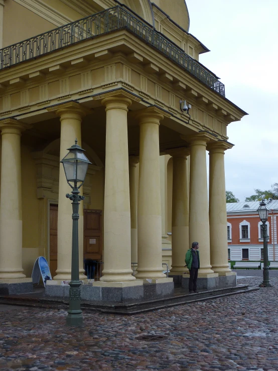 a person standing by an old stone building