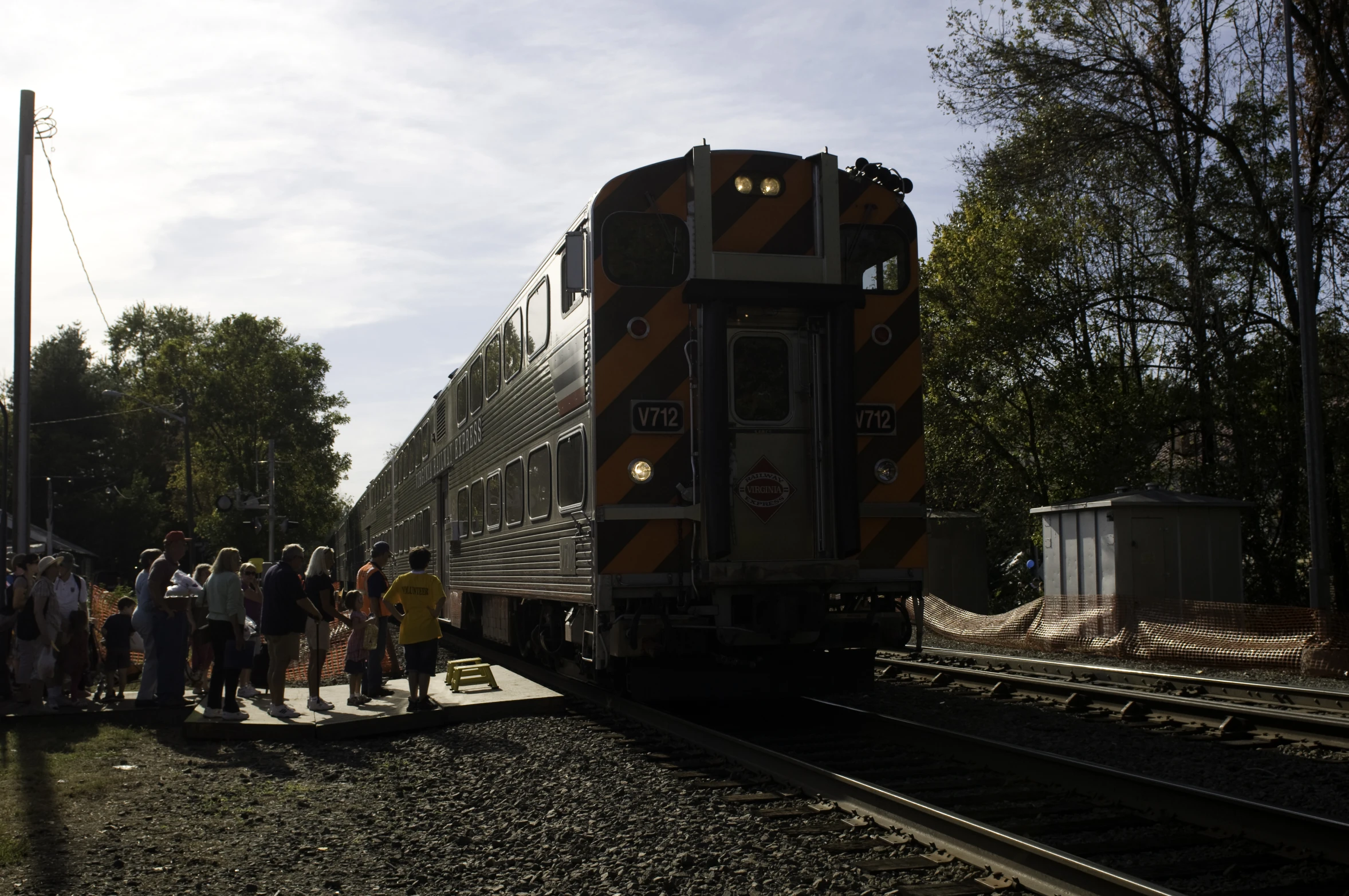 a train is parked as people are standing on the tracks