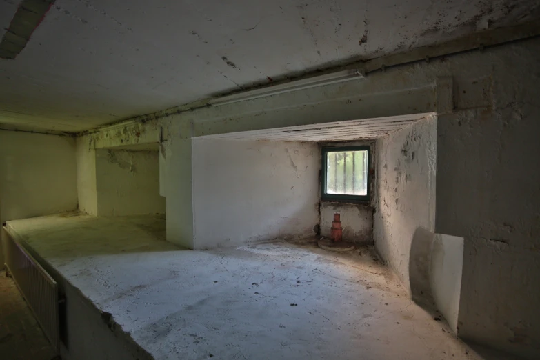 an unfinished room with the window partially opened