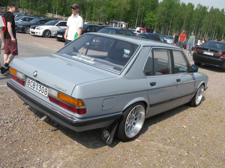 a vintage bmw coupe sits at a car show