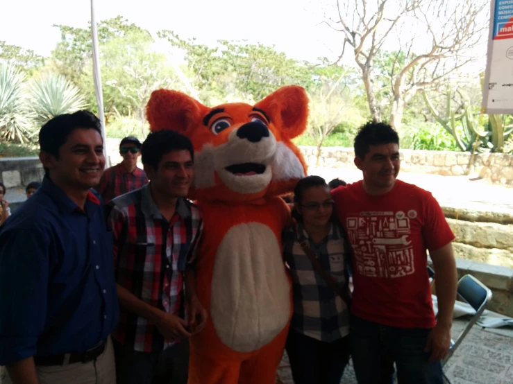 there are several people posing with the mascot