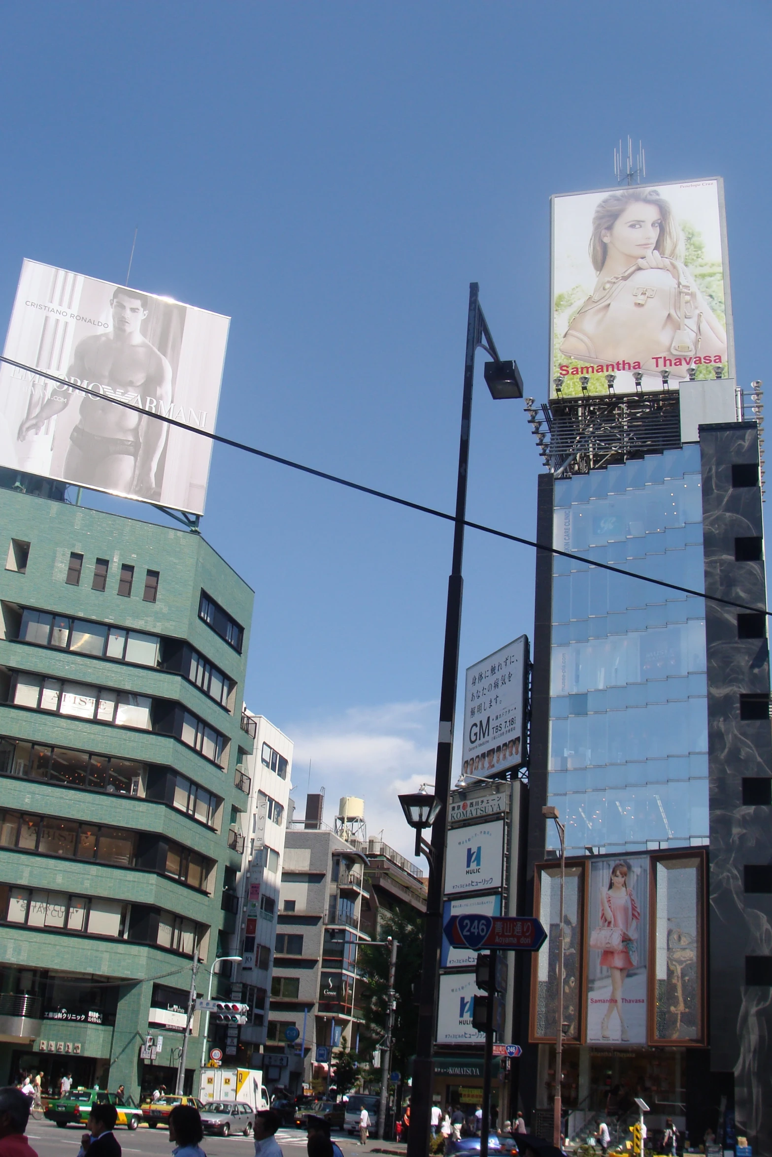 some tall buildings and street lamps in front of them