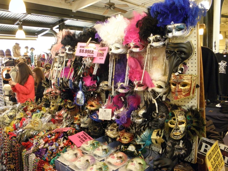 a number of mask on a display at a market