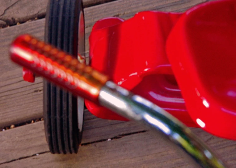 a red toy wagon on a porch and two smaller bowls