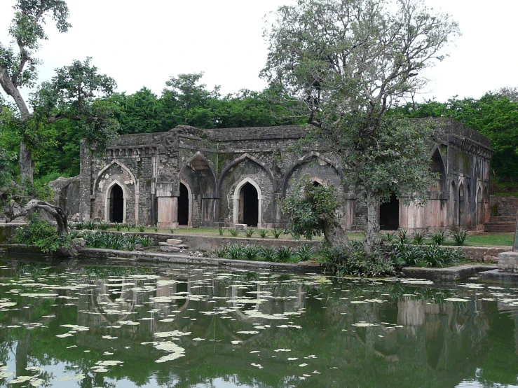 a big body of water near a building and trees