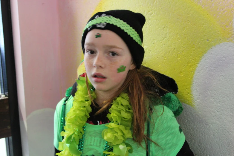 there is a young woman with a colorful head decoration