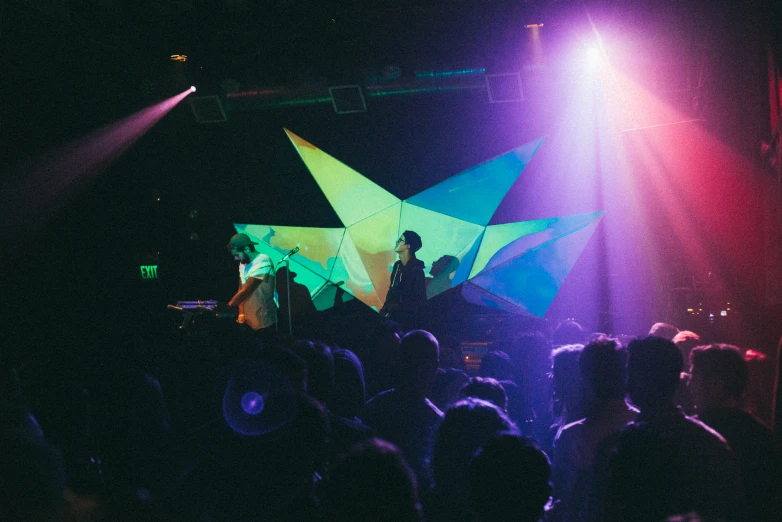 stage lights shine brightly on a concert scene as the singer sings