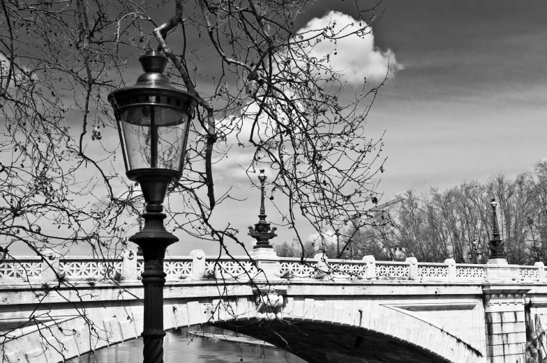 a street light hanging off of the side of a river