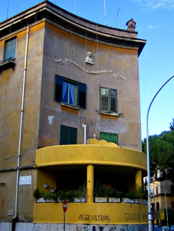 the corner of a building with windows and balconies