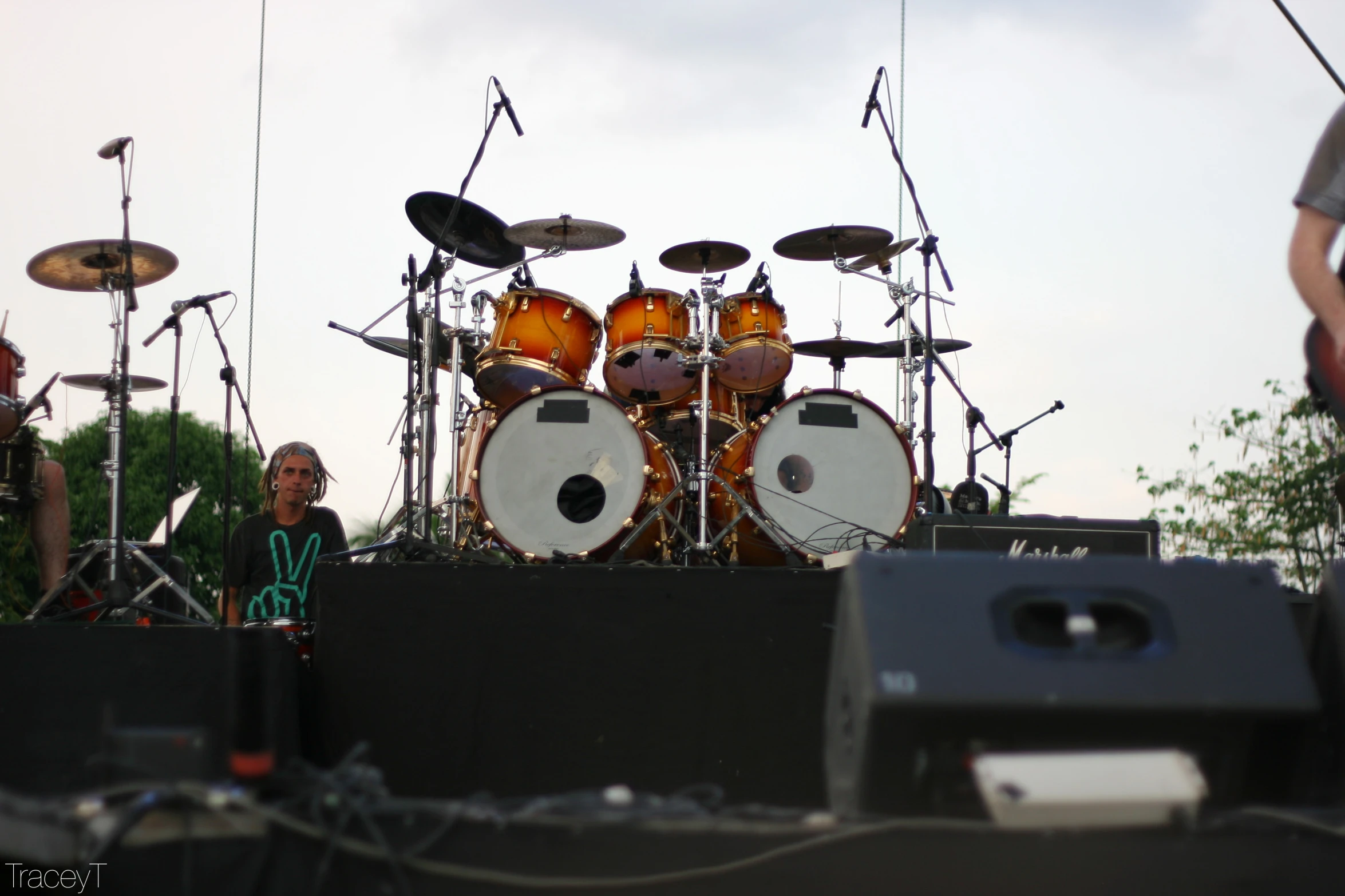 a band on stage with drummers on one of the drums